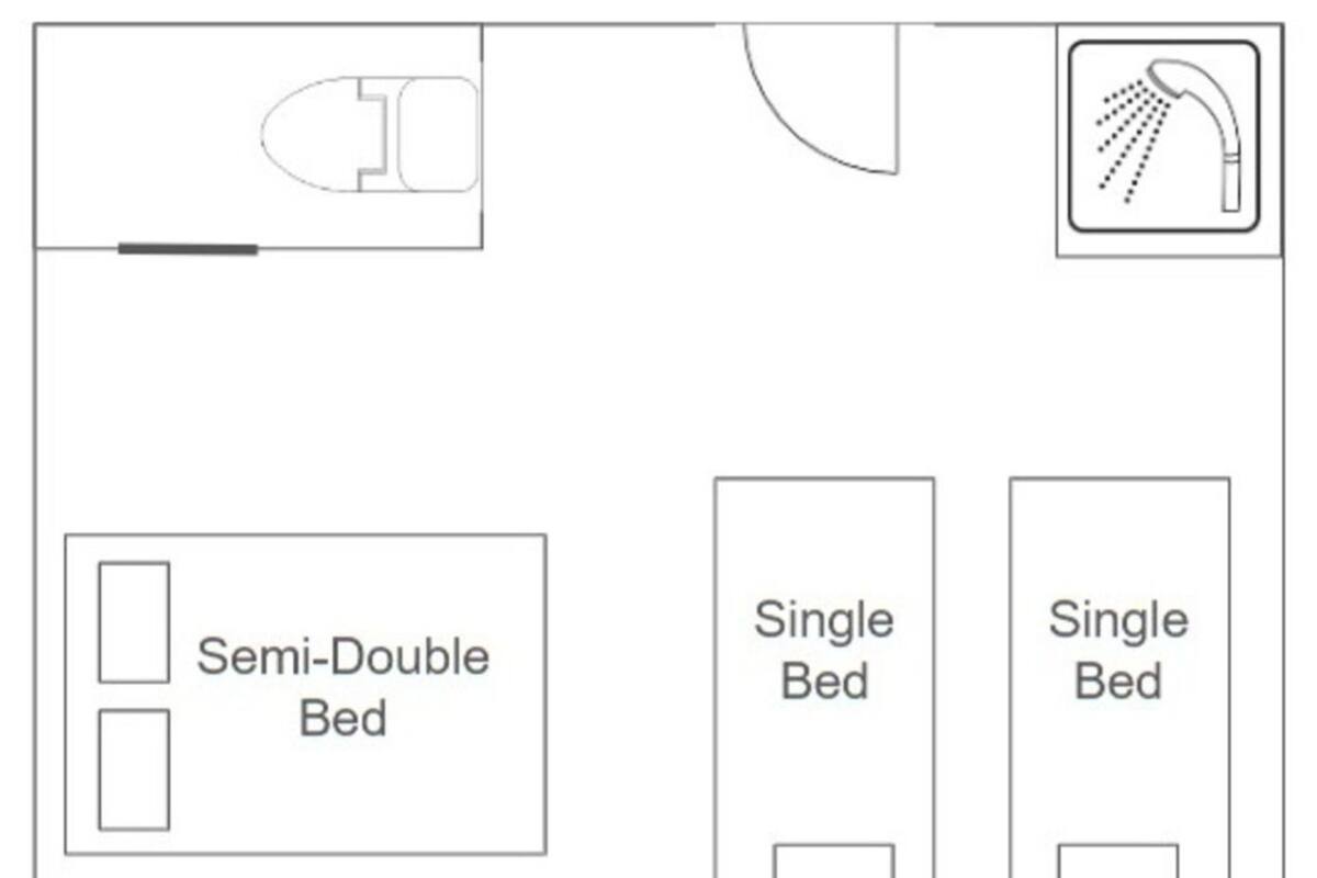 A room layout with a semi-double bed, two single beds, a toilet, and a shower.