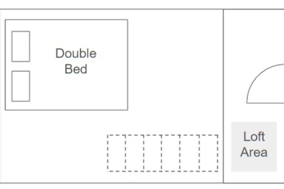 A room layout with a double bed and a loft area.