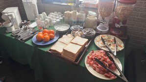 A breakfast buffet with various food items and utensils. - Daiju Myoko (Myoko)