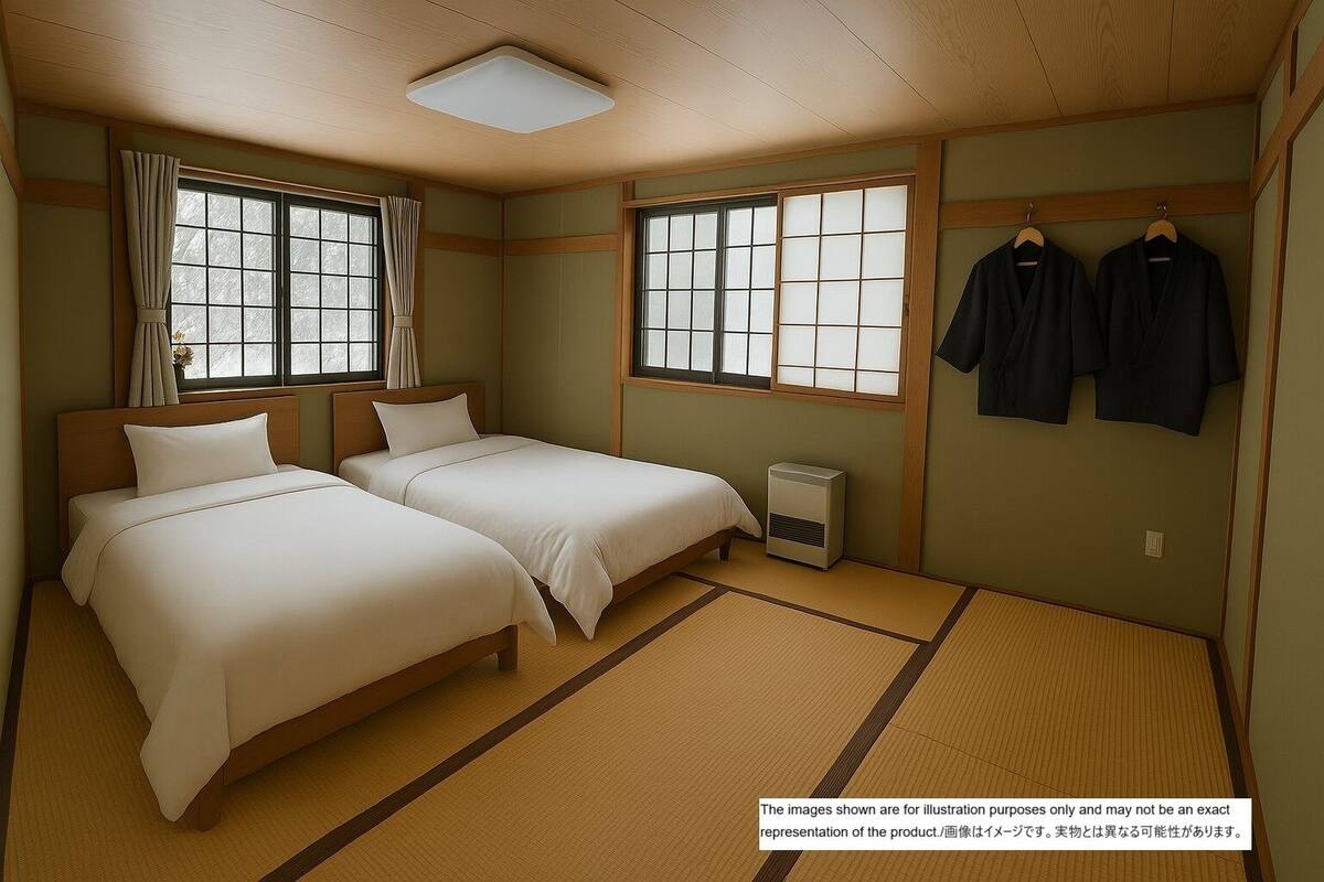 A traditional Japanese-style room with tatami flooring, two beds, a heater, and sliding doors.