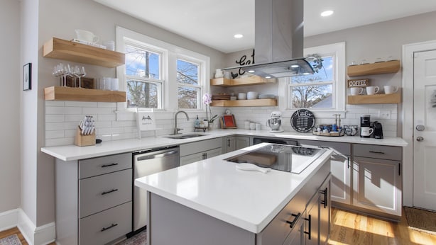 A modern kitchen with white countertops, grey cabinetry, and wooden shelves. - Swamp Rabbit | Furman | Bikes | Pass | Fenced | EV (Greenville)