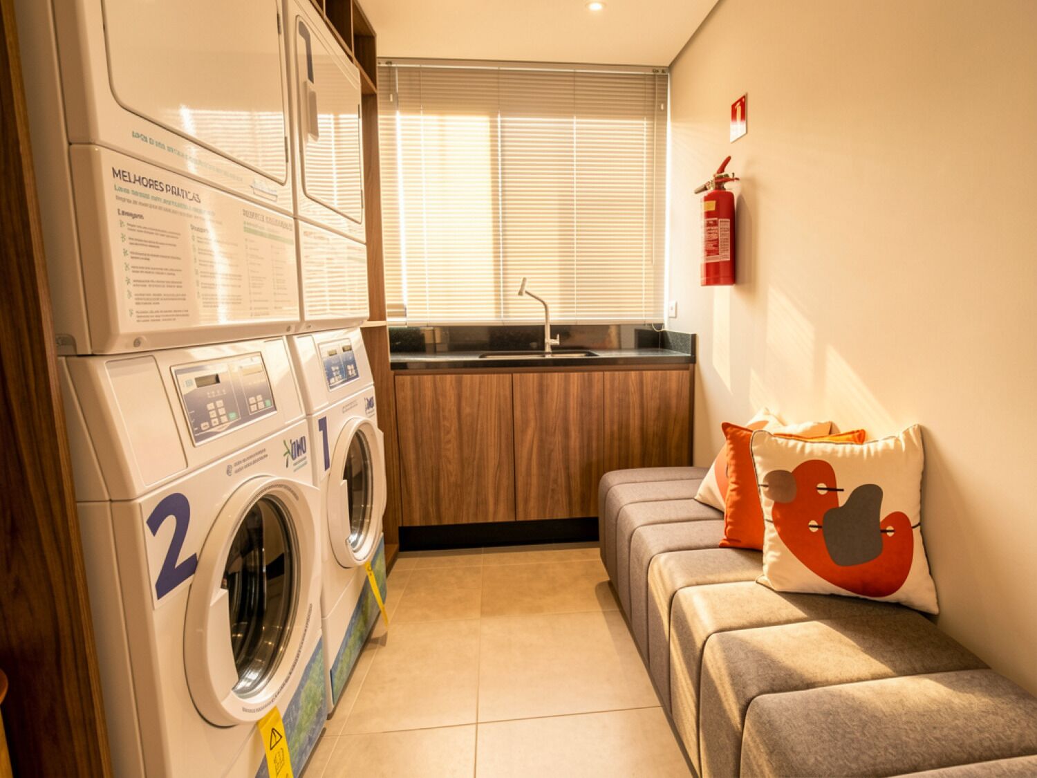A compact laundry room with a washing machine, a dryer, and a small kitchenette.