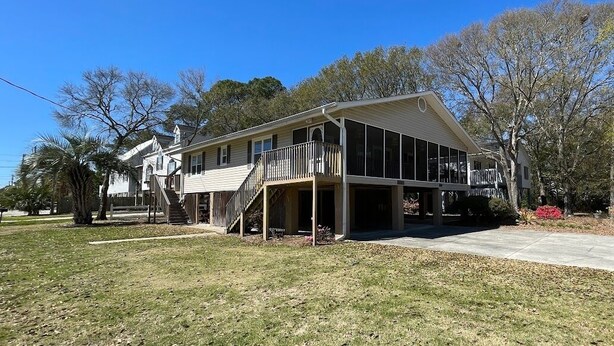 A two-story house with a covered porch and a staircase leading to the second floor. - 1 block from beach! 4bed 2bath Beachhouse. Just had a cancelation in July.  (Surfside Beach)