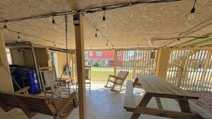 A covered outdoor area with picnic tables and hanging lights. - 1 block from beach! 4bed 2bath Beachhouse. Just had a cancelation in July.  (Surfside Beach)