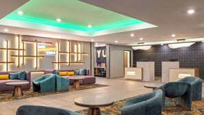 A modern lobby with sofas, armchairs, and a reception desk. - La Quinta Inn & Suites By Wyndham Yuma (Yuma)