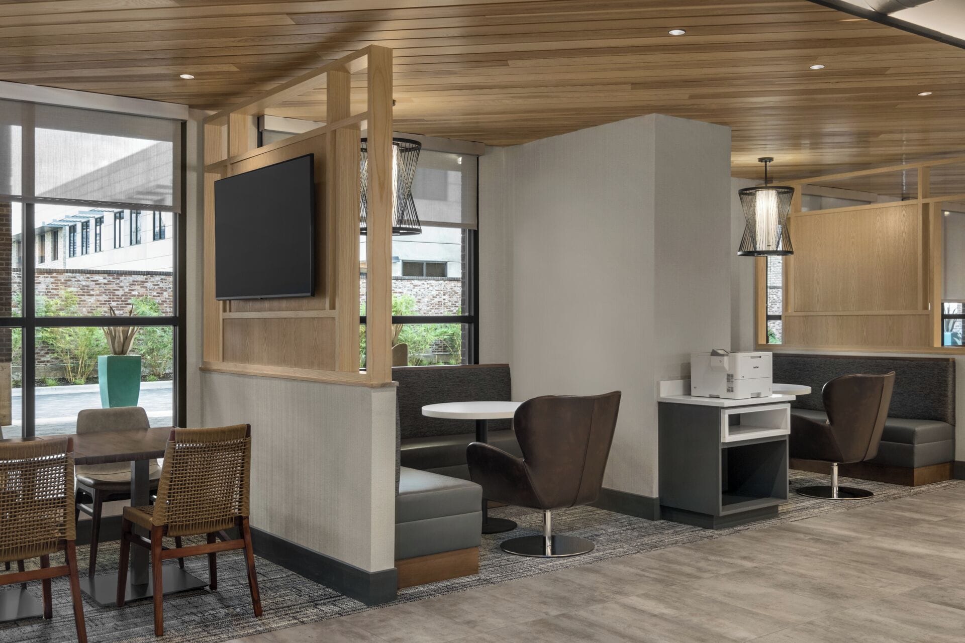 A modern interior with a seating area, a flat-screen TV, and a printer.