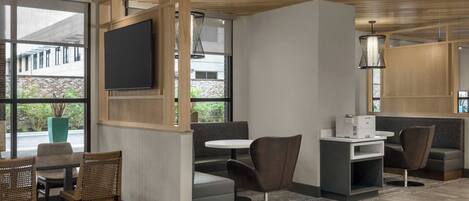 A modern interior with a seating area, a flat-screen TV, and a printer.
