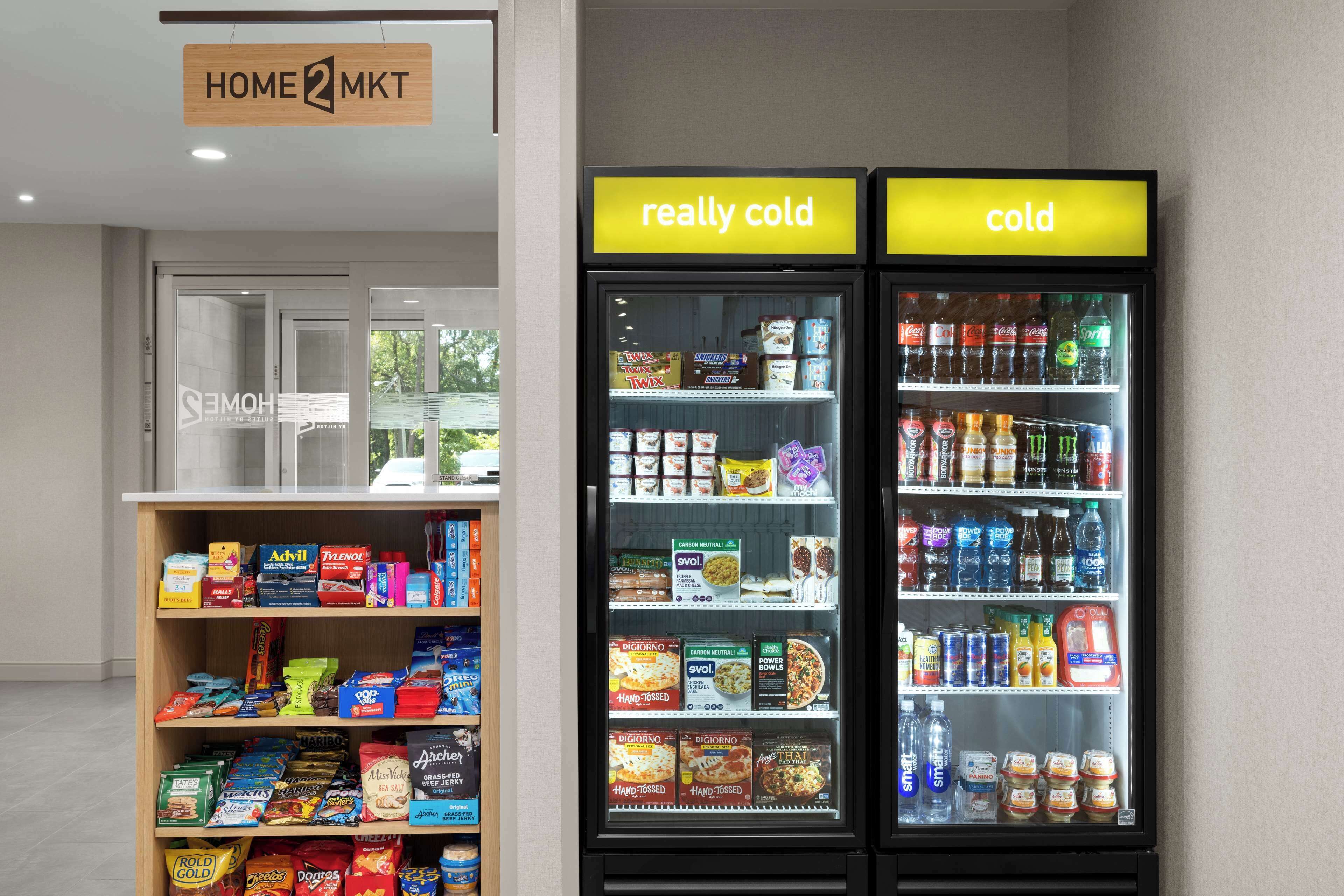 A vending machine with snacks and drinks, and a shelf with packaged goods.