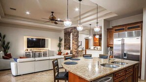 A spacious kitchen with granite countertops, stainless steel appliances, and a central island with seating. - Epic Resort: Pool, Hot Tub, Pickleball & More! (Chandler)