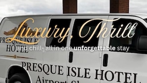 A luxury shuttle branded as Presque Isle Hotel Airport Shuttle.