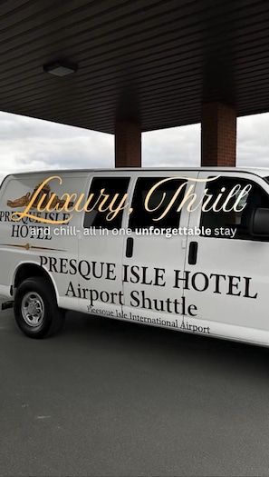 A luxury shuttle branded as Presque Isle Hotel Airport Shuttle.