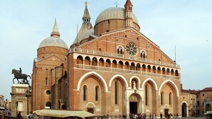A historic building with multiple domes and a prominent clock tower.