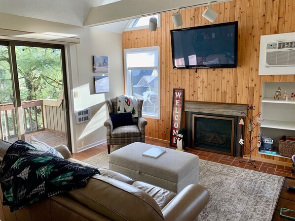 A cozy living room with a fireplace, a television, and a comfortable seating area. - Prime Location! Clean 3 BDRM/3 FULL BATH. Next to MountainAdventures & MainLodge (Clymer)