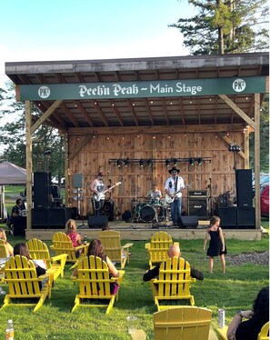 A stage with a band performing, surrounded by yellow chairs and a covered seating area. - Prime Location! Clean 3 BDRM/3 FULL BATH. Next to MountainAdventures & MainLodge (Clymer)