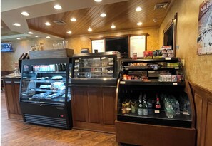 A self-service beverage station with a refrigerated display case and a selection of snacks and hot drinks. - Prime Location! Clean 3 BDRM/3 FULL BATH. Next to MountainAdventures & MainLodge (Clymer)