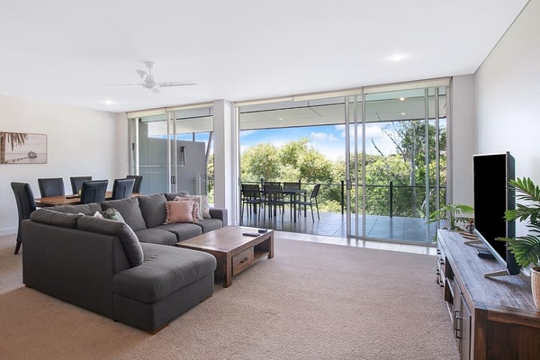 Relax in the open-plan living area, complete with a generous sofa inviting you to settle in with a movie while central air-conditioning and heating ensure year-round comfort.