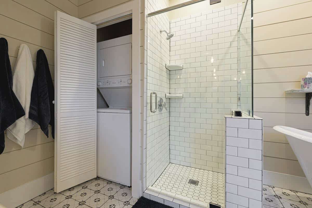 A bathroom with a walk-in shower, a toilet, and a bathtub.