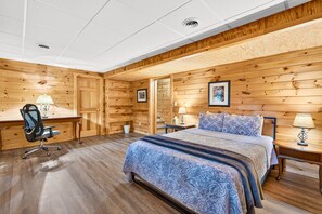 A bedroom with a bed, a desk, a chair, and a lamp. - Casa Carezza, Pet Friendly (Logan)