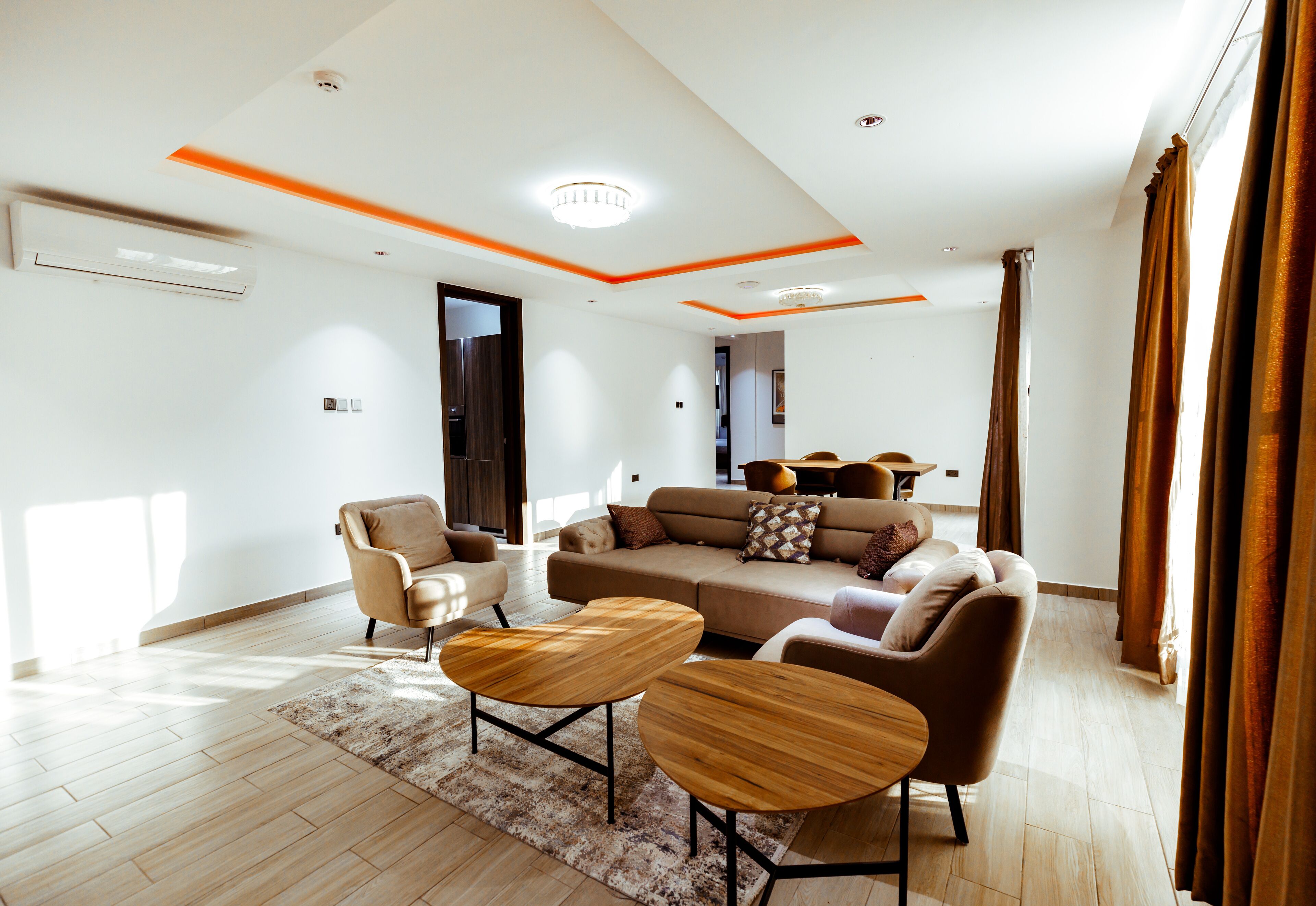 A modern living room with a sofa, armchairs, and a coffee table.