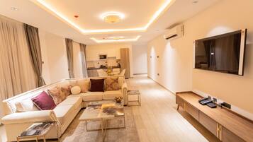 A modern living room with a sofa, coffee table, and TV.