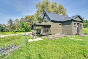 Ein eingeschossiges Haus mit Veranda, Metalldach und kleinem Vorgarten.