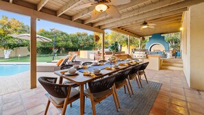 An outdoor patio with a dining table set for four, surrounded by wicker chairs. - Free Heated Pool ~ Hot Tub ~ Basement Game Room ~ Large Backyard (Mesa)