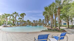 A pool area with palm trees, a bridge, and lounge chairs. - Palms of Destin Resort Condo: Beaches, Golf & More (Destin)