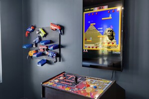 A pegboard with various toys and a retro video game console.