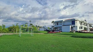A modern two-story house with a well-maintained lawn and a soccer goal. - Hotel Palmas De Alcalá (Alcalá)