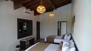 A hotel room with two beds, a flat-screen TV, a small desk, and a ceiling fan. - Hotel Palmas De Alcalá (Alcalá)