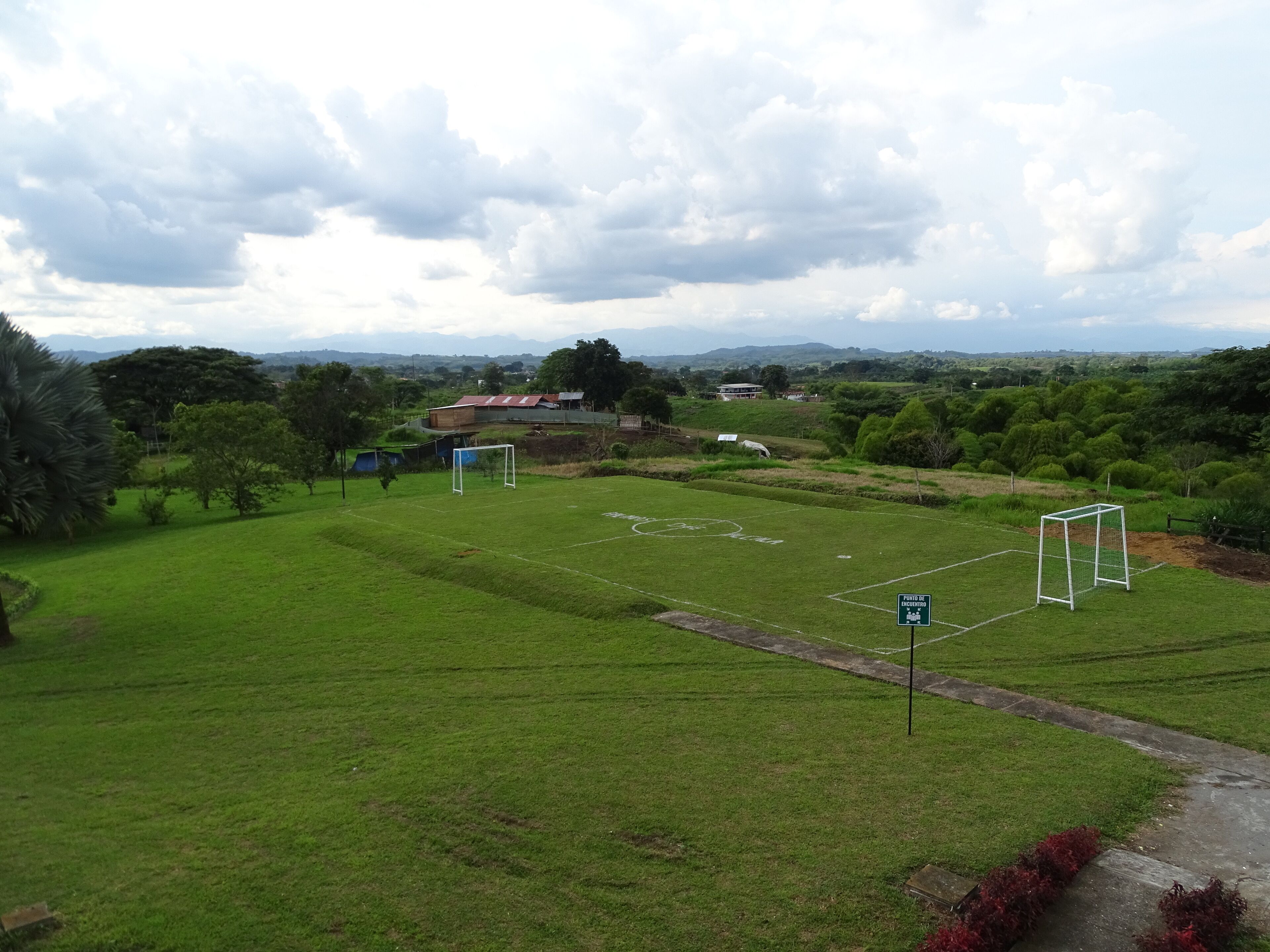 A soccer field with goalposts and a sign indicating a parking area.