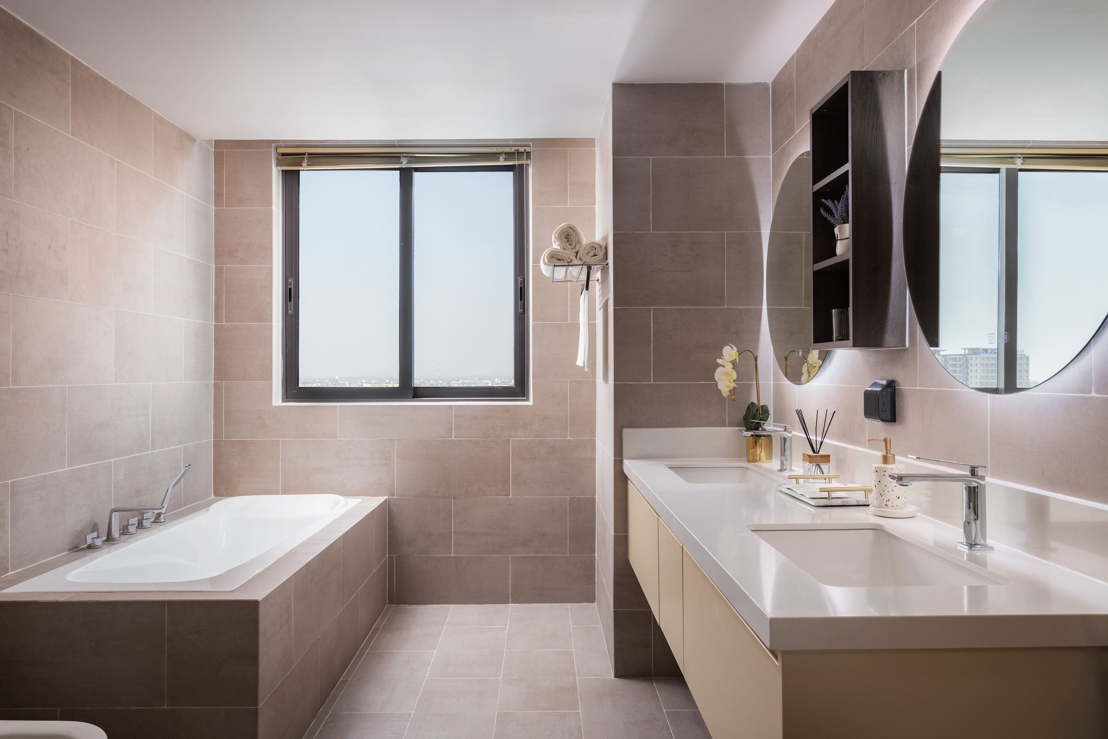 A modern bathroom with a bathtub, a sink, and a large mirror.