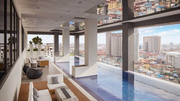 A modern rooftop lounge with a pool, offering panoramic city views.