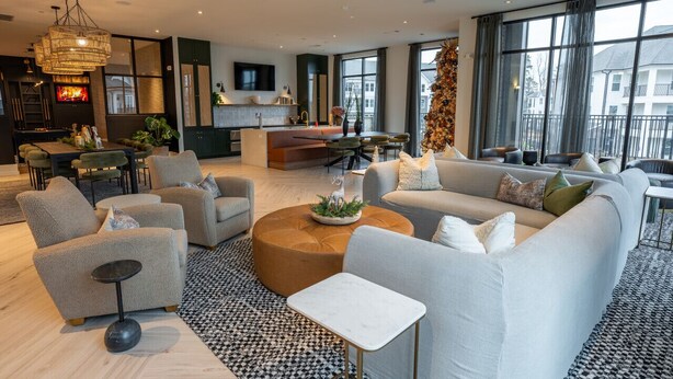 A modern living room with a sofa set, a coffee table, and a dining area. - Luxurious, New Apt | Pool | Long Stays (Athens)