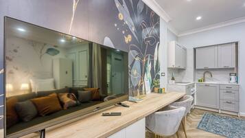 Family Studio (Boutique Downtown Studio with Balcony) | Living area | 21-inch flat-screen TV with digital channels