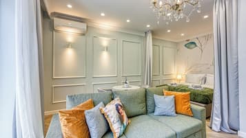 Family Studio (Boutique Downtown Studio with Balcony) | Living area | 21-inch flat-screen TV with digital channels