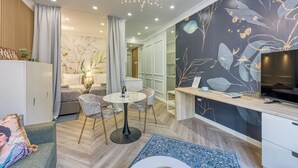 A modern living room with a sofa, a round table, and a TV.