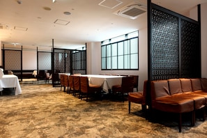 Relax in a spacious room with a large window, seating area, and comfortable sofas.