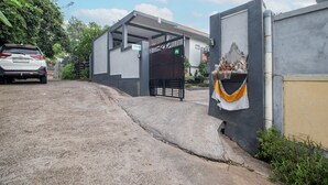 Una entrada con puerta protegida a un edificio, con un letrero que indica una zona de estacionamiento.