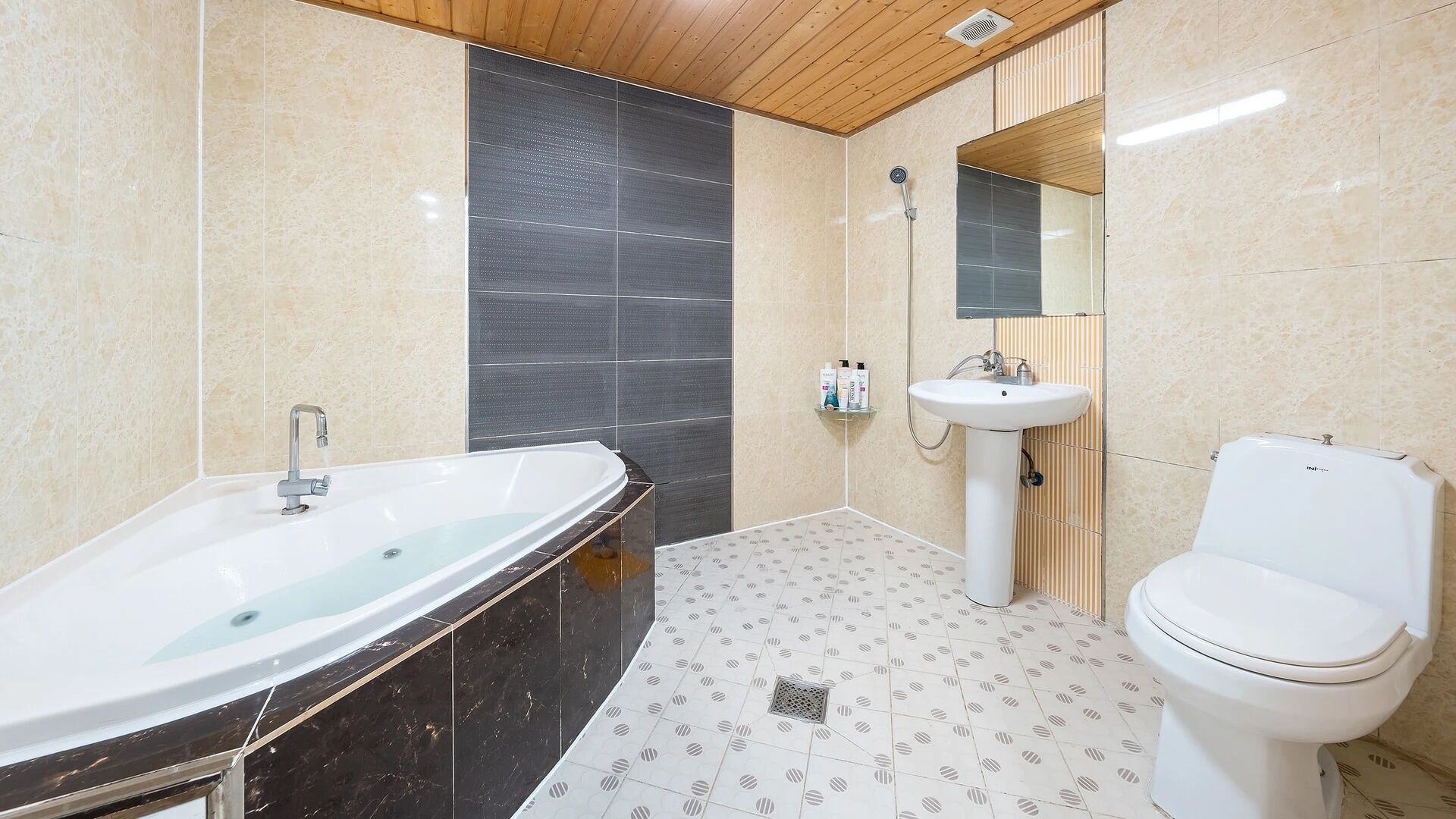 A bathroom with a bathtub, sink, toilet, and a shower.