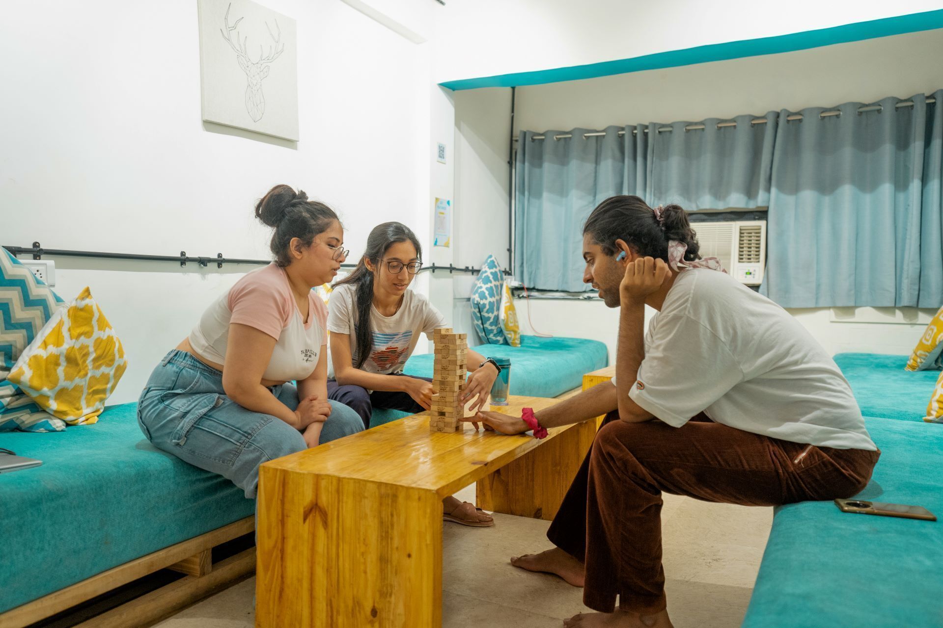 A group of people sitting on a couch and playing a game.