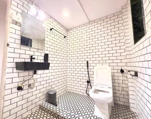 Dormitorio compartido estándar | Baño | Regadera, regadera tipo lluvia, secadora de cabello, papel de baño 