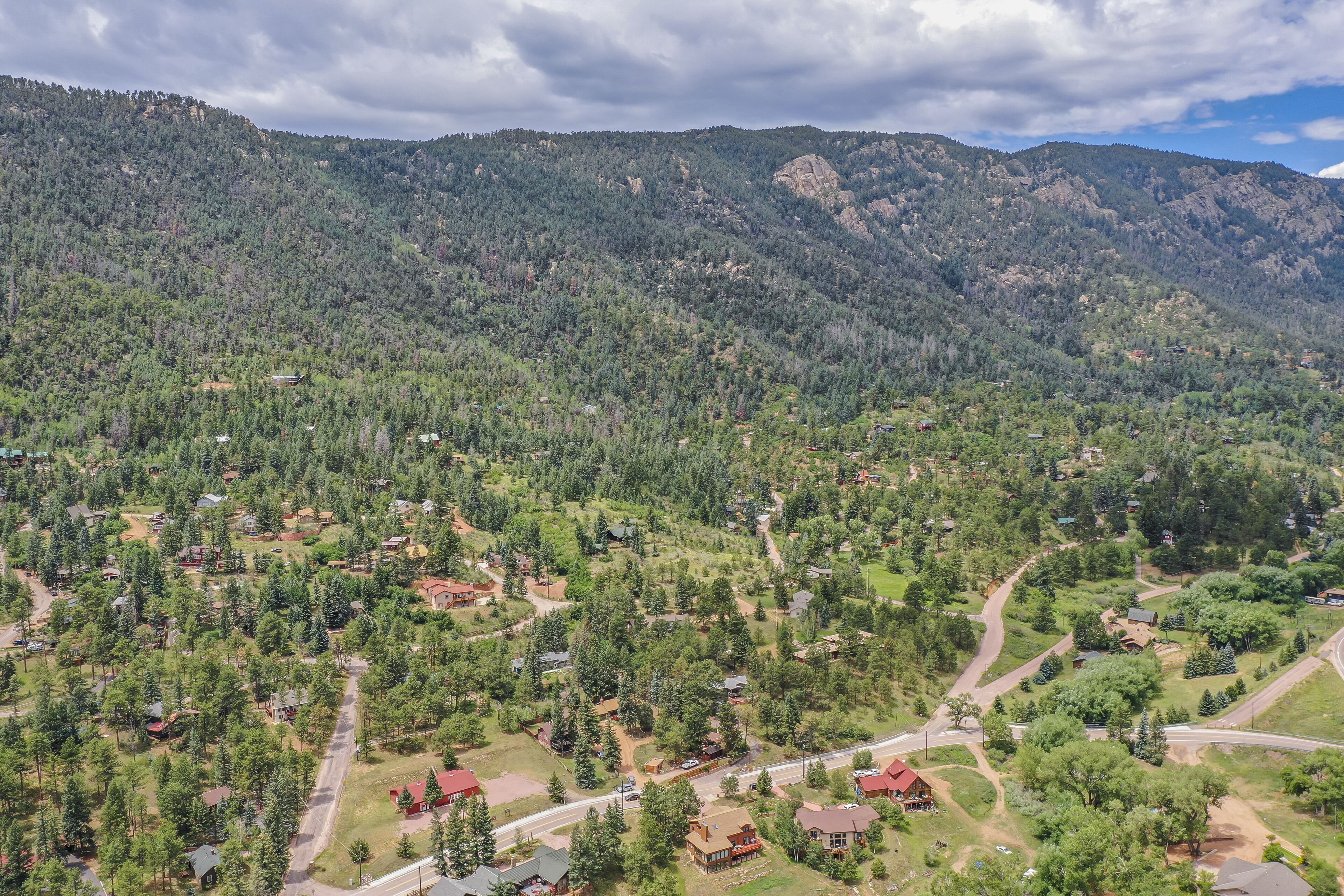 A mountainous landscape with scattered houses and roads.