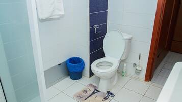 Standard Apartment | Bathroom | Shower, towels, soap, toilet paper