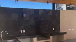 A modern kitchen with a built-in oven, a sink, and a countertop.