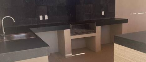 A modern kitchen with a built-in oven, a sink, and a countertop.