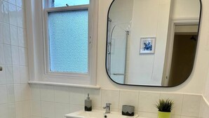 A bathroom with a bathtub, toilet, and sink. - 2 Bedroom House in Central Winchester (Winchester)