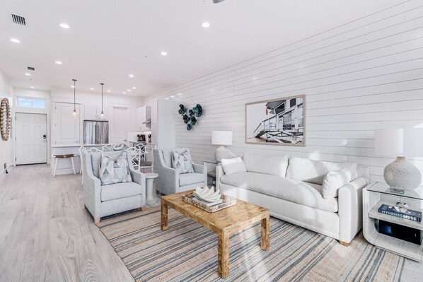 Relax in this inviting living space, featuring a comfortable sofa, armchair, and stylish coffee table.