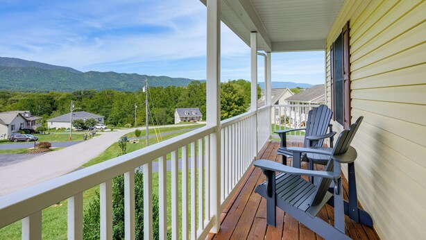 A porch with a view of a residential street and green hills. - Hike Shenandoah! Family-friendly House w/ Deck (Shenandoah)