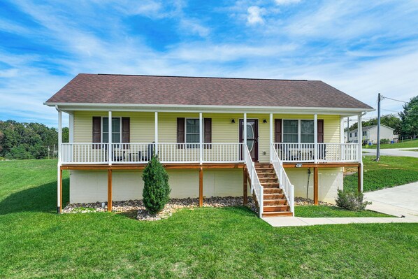 A two-story house with a front porch, a covered front entrance, and a small front yard. - Charming Shenandoah Retreat w/ Deck & Grill! (Shenandoah)
